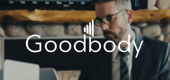 Goodbody logo over the top of an image of a person wearing a suit
