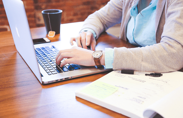 person at desk with laptop