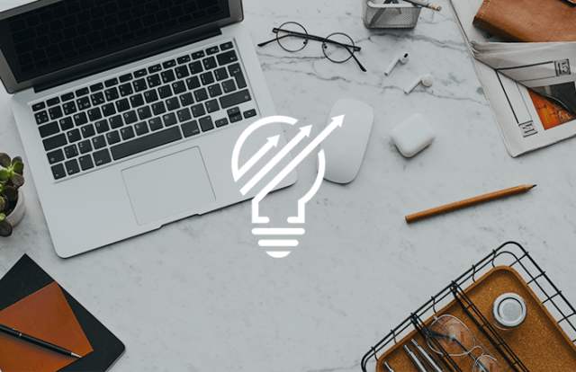 lightbulb icon over an image of a laptop and desk