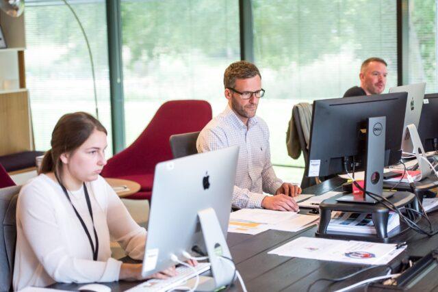 people working at computers in an office