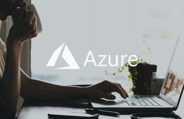 Azure logo laid over an image of hands on laptop
